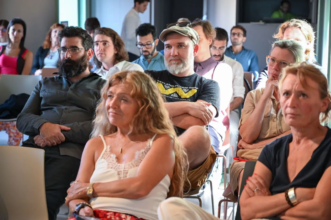 The audience follows the startup presentations